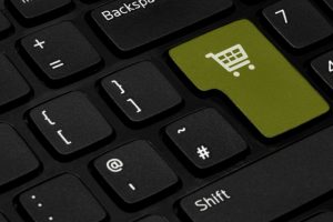 A keyboard with the enter key replaced with a shopping basket icon.